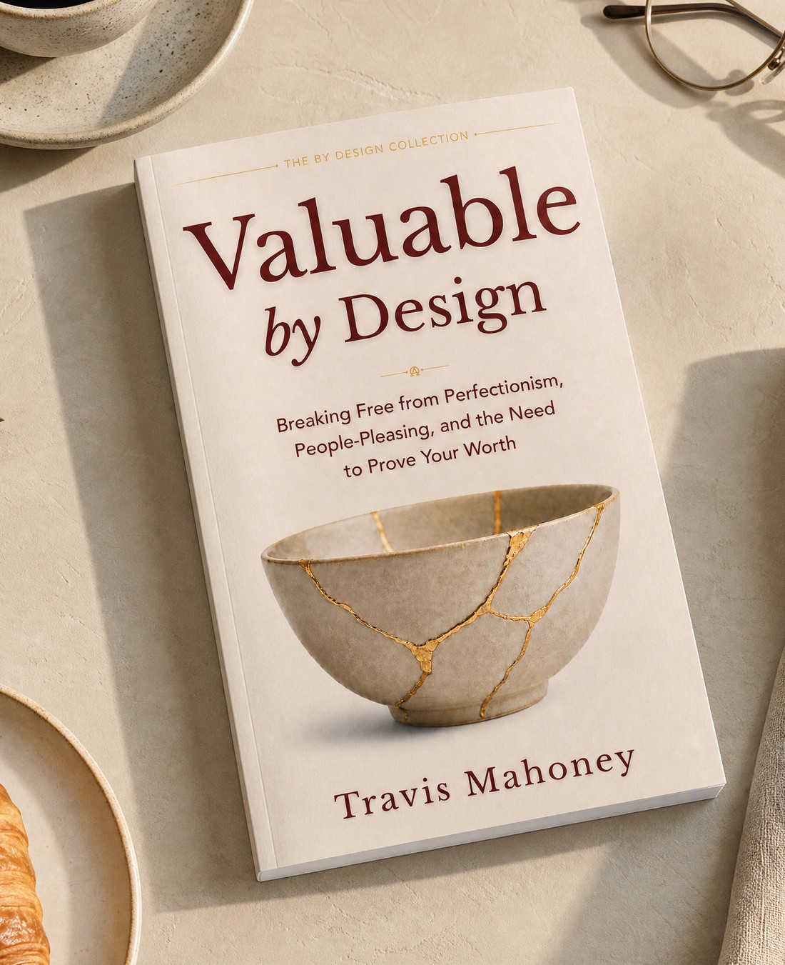 Valuable by Design — the book on a table with coffee