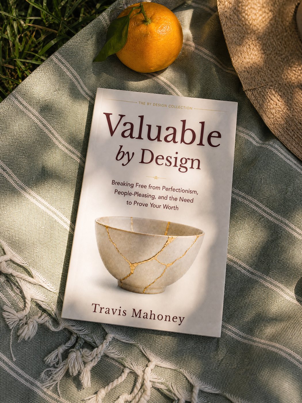 Valuable by Design on a picnic blanket with an orange and sun hat
